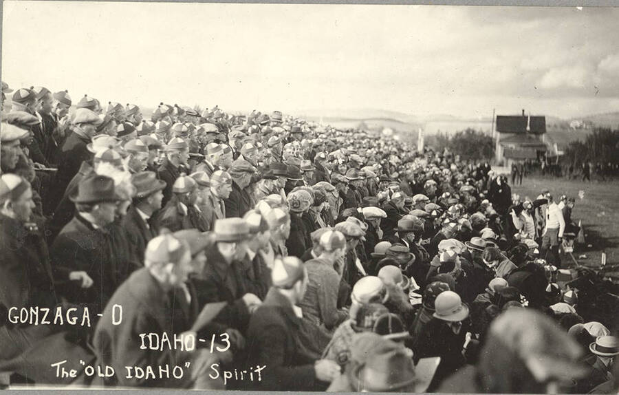 A side angle photograph of the student cheering section during a football game. Caption reads: Gonzaga-0 Idaho-13, The 'Old Idaho' Spirit.