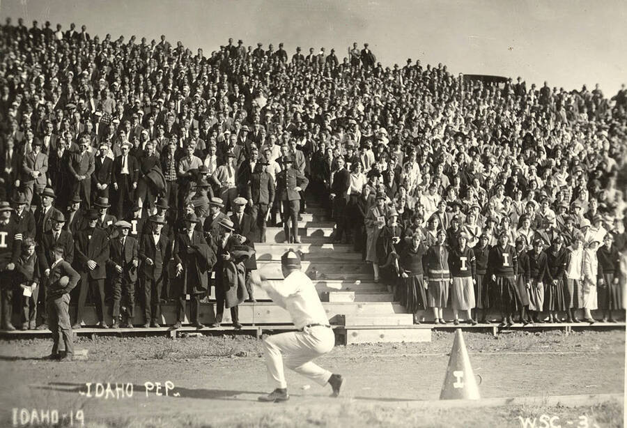 Yell Kings and Dukes lead the student cheering section in a coordinated cheer during a football game. Caption reads: -Idaho Pep-Idaho-19 -W.S.C.-3.