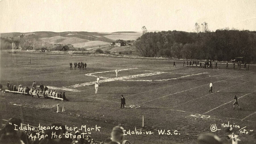 Yell Kings and Dukes participate in the Idaho Stunt for the Harvard Yell Contest during a football game. Caption reads: Idaho Leaves her Mark After the Stunt, Idaho vs. W.S.C. #8.