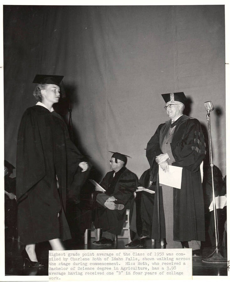 Charlene Roth, the student with the highest grade point average of class of 1958, walks across stage during the Commencement ceremony.