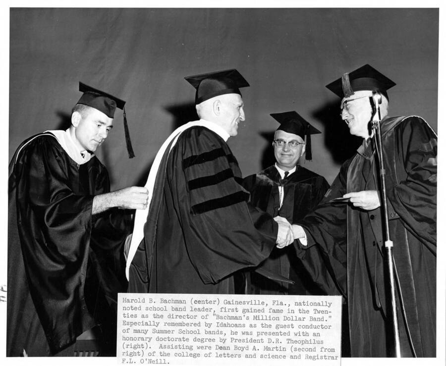 Harold B. Bachman (center) receives an honorary doctorate degree from University of Idaho president D. R. Theophilus (right) during the 1963 Commencement ceremony. Dean Boyd A. Martin (behind) and Registrar F.L. O'Neill (left)