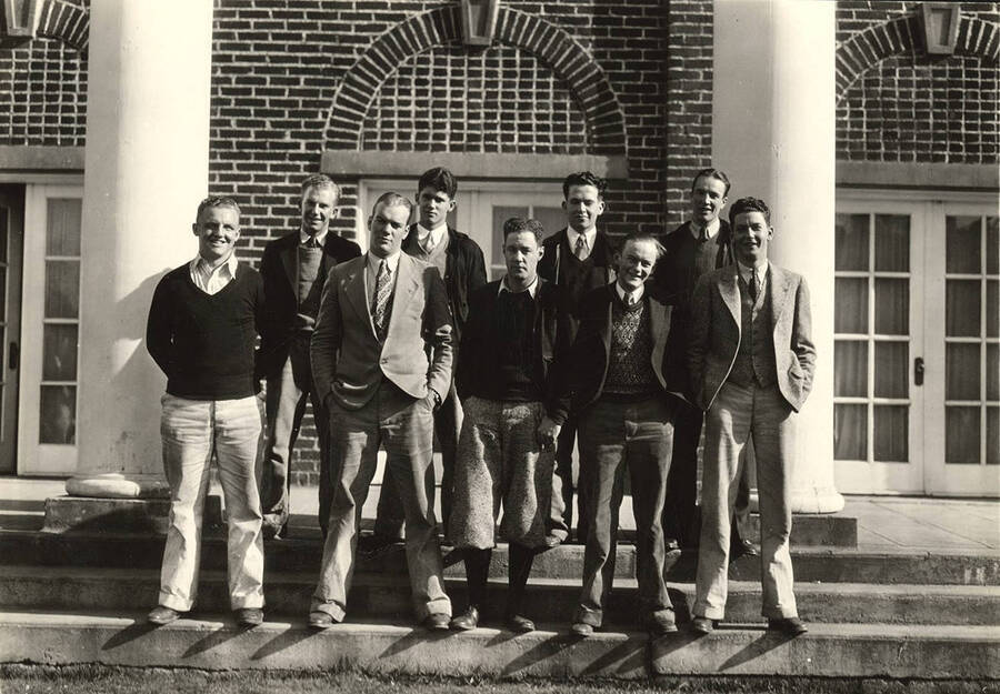 The nine men from the Kappa Sigma championship intramural swim team stand for a photograph outside of Kappa Sigma.