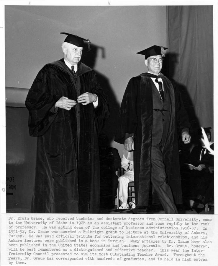 Dr. Erwin Graue (left) upon his retirement during the 1965 Commencement ceremony. Dr. Graue was the recipient of the 'Most Outstanding Teacher' award. Photographer Publications Department