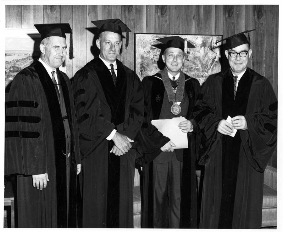 Recipients of honorary degrees during the 1966 Commencement ceremony with University of Idaho President Ernest W. Hartung. From left to right: LeRoy Tillotson, William F. Johnston, President Hartung, and Governor Robert E. Smylie. Photographer Publications Department