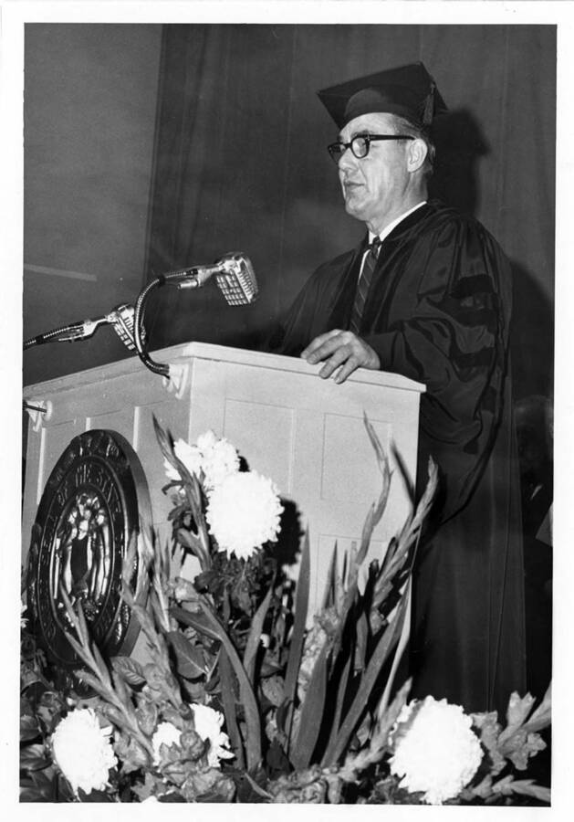 Governor Robert E. Smylie speaking during the 1966 Commencement ceremony. Photographer Publications Department