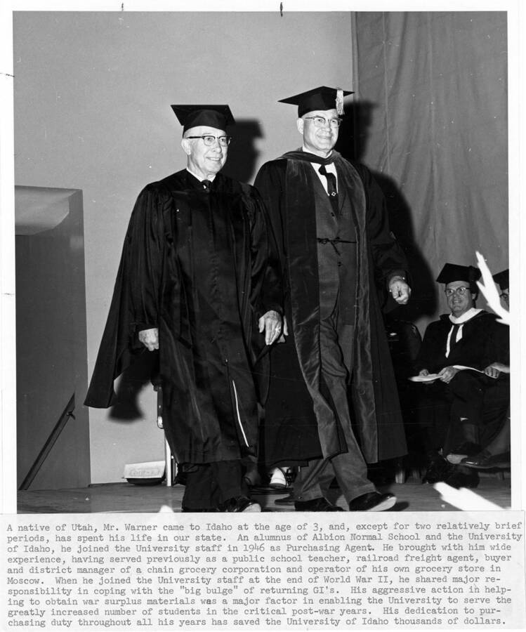 L.C. Warner (left), University of Idaho purchasing agent, upon his retirement at the 1965 Commencement ceremony. Photographer Publications Department
