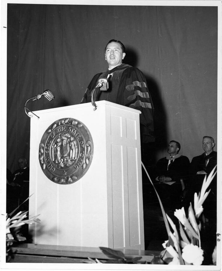 Carl W. McIntosh, president of Idaho State College, delivers his address as Commencement speaker during the 1956 Commencement ceremony. Photographer Publications Department