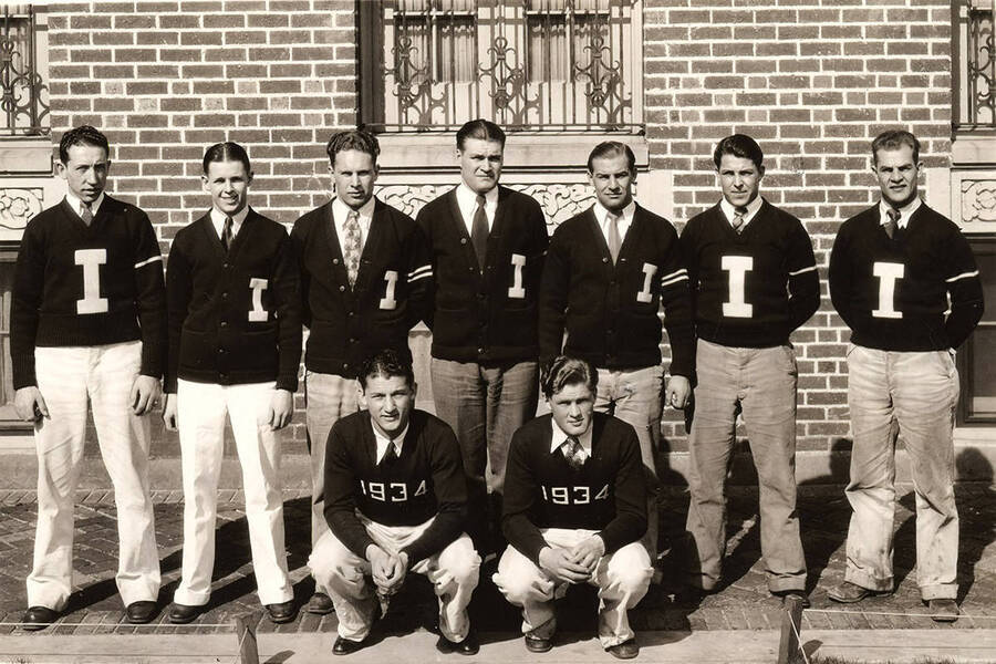 A group photo of Alpha Tau Omega lettermen and numeral men posing outside of Alpha Tau Omega.