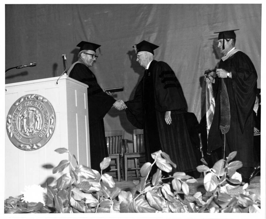 Dr. H. Walter Steffens, retiring Academic Vice President, receiving an honorary Doctor of Laws degree from University of Idaho President Ernest W. Hartung during the 1969 Commencement ceremony.