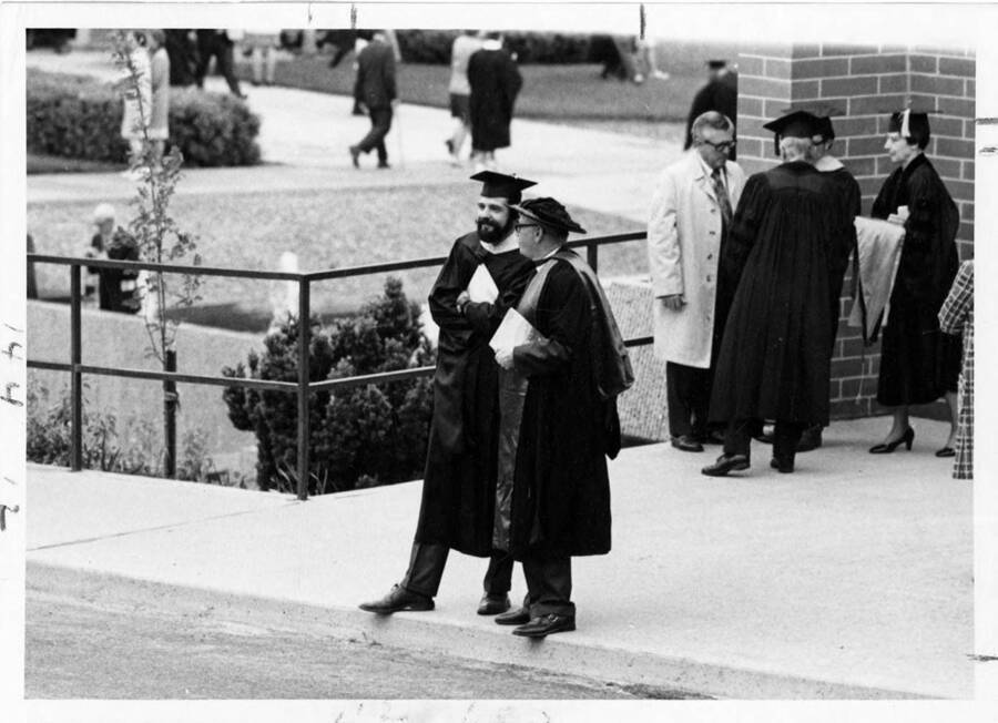 Several faculty members in caps and gowns for the 1971 Commencement. On right, with back to camera, Dr. Alvin Aller. To his right is Dr. Florence D. Aller.
