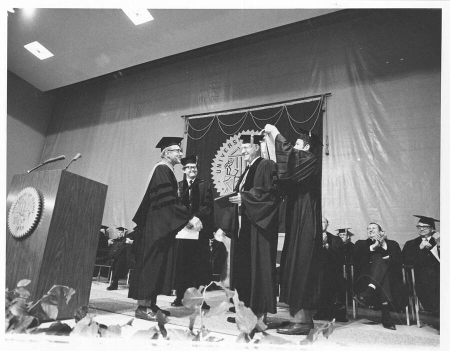 Merrill Dee Beal receiving an honorary Doctor of Humane Letters degree during the 1971 Commencement ceremony.