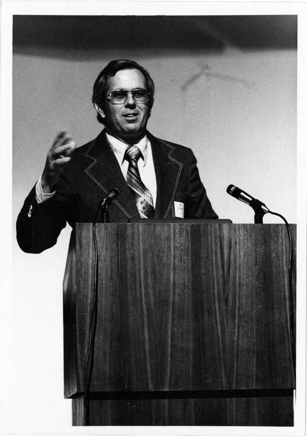 Alumni Association president William W. delivers a speech during the 1975 Commencement ceremony.