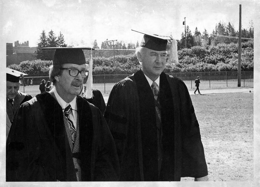 John Corlett and Governor Cecil D. Andrus, recipients of honorary Doctorate degrees, dressed in their caps and gowns for the 1976 Commencement ceremony.