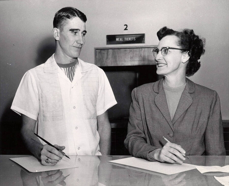 Mrs. C.E. Willis and son, Donald, registering as freshmen.