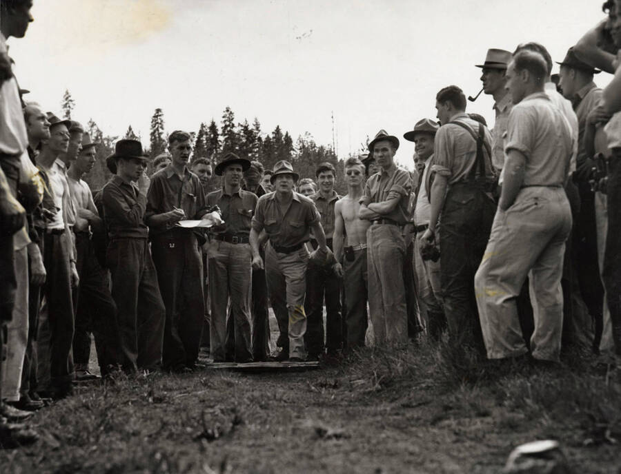 Red Ahler, along with other students, participate in a tobacco spitting on contest while Ernie Taylor keeps tally during the Associated Foresters barbeque.