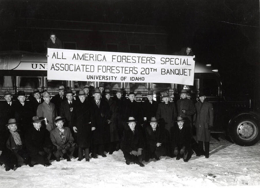 Group picture of the Associated Foresters taken outside, in front of a bus before the  All America Forester's Special Associated Forester's 20th Banquet.