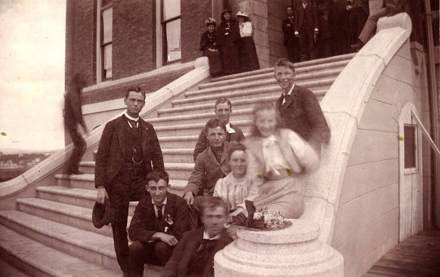 A group portrait of students sitting on the old Administration Building stairway.