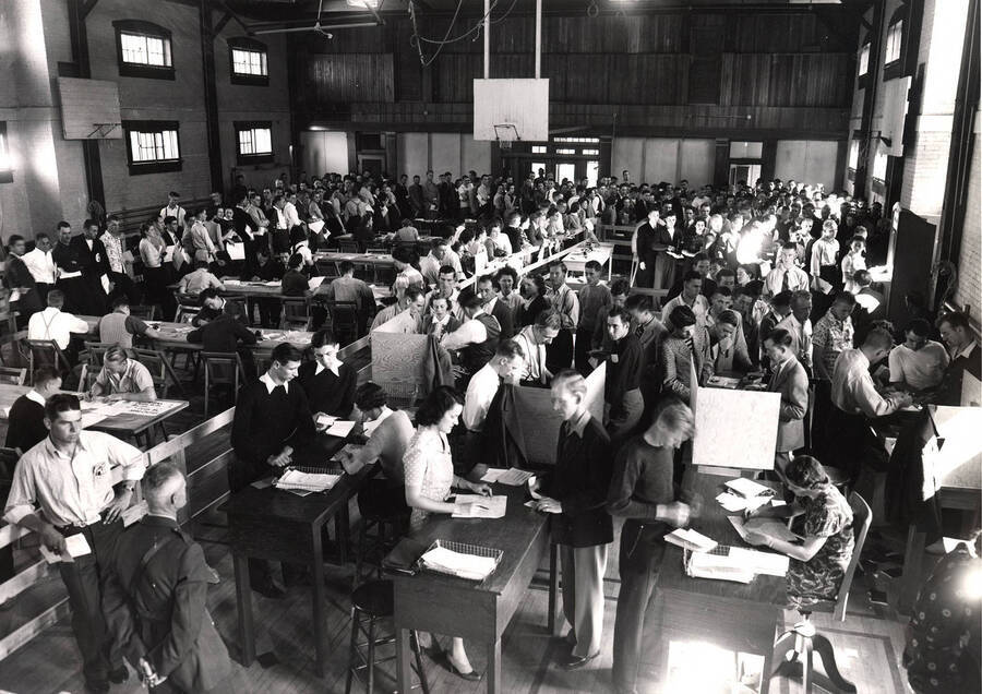 Students fill out schedule cards, wait in line, and register for courses in the Women's Gymnasium. The Women's Gym became Art and Architecture South in 1976.