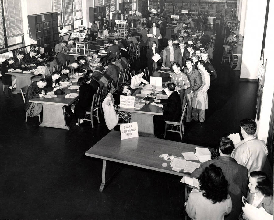 Students register for classes in the library, located in Administration Building in this picture. The library moved into its own building in 1957.