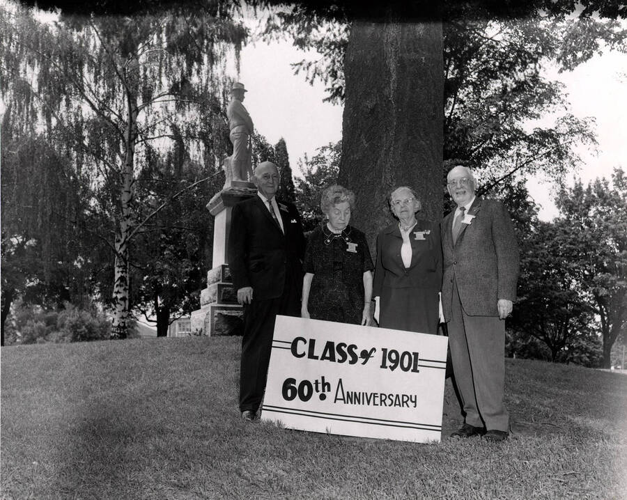 Members of the class of 1901 pose for their 60th anniversary photo by the Old Guard statue on the Administration Lawn. Pictured left to right: Carroll Smith, Minnie Galbreath Marcy, Carrie Tomer Hays, and Homer David