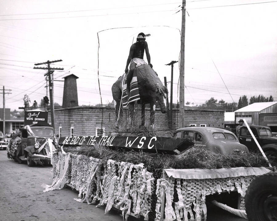 An unassociated float features an individual in Native American dress on a horse.The banner on the float reads: 'The End of the Trail WSC'.