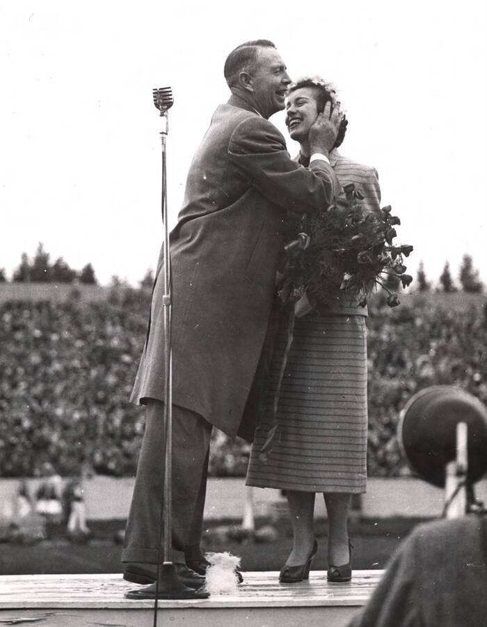 Governor Len Jordan gives newly crowned Homecoming queen Leah Jensen the traditional kiss during the Homecoming game.