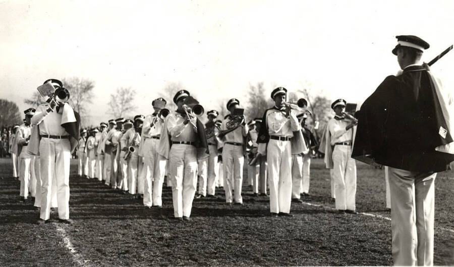 The Vandal Marching Band plays on the football field from a block formation.