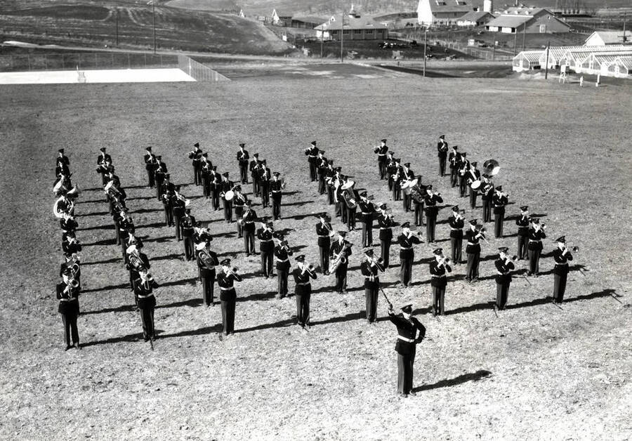 The University of Idaho Military Band rehearses in block formation near the football field.
