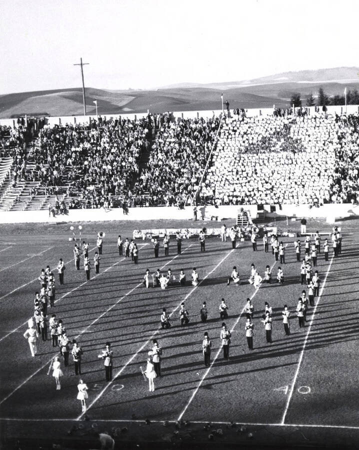 The Vandal Marching Band is caught in a marching set during the half-time performance at a football game.