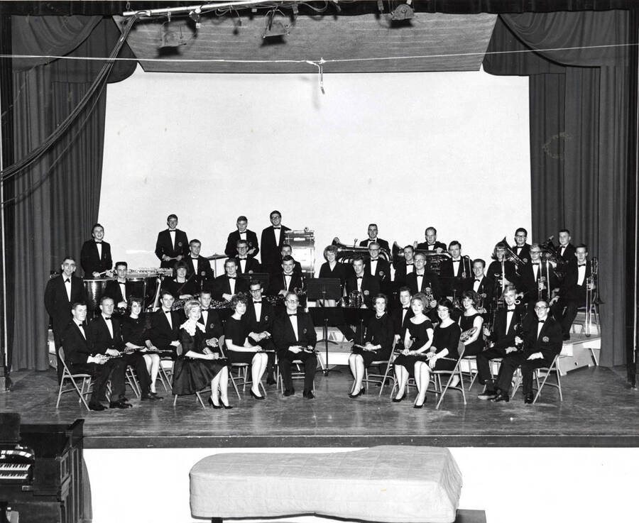 The University Concert Band sits for a group photo in their concert blacks.