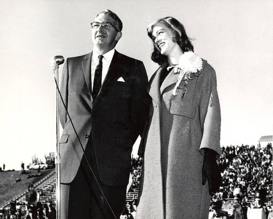 Celeste Jones, Homecoming queen, waits to be crowned and stands beside an unidentified man on stage at MacLean field.