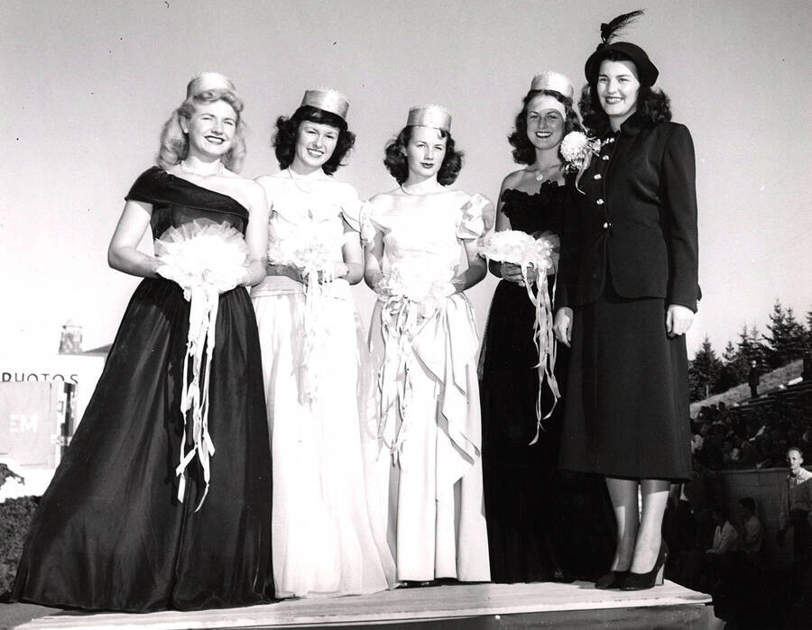 Glenda Bergen (right), Miss Spokane, crowns princesses at Homecoming.  Princesses listed left to right: Carolyn Johanson, Doris Moore, Betty Hogan, Gayle Slavin.