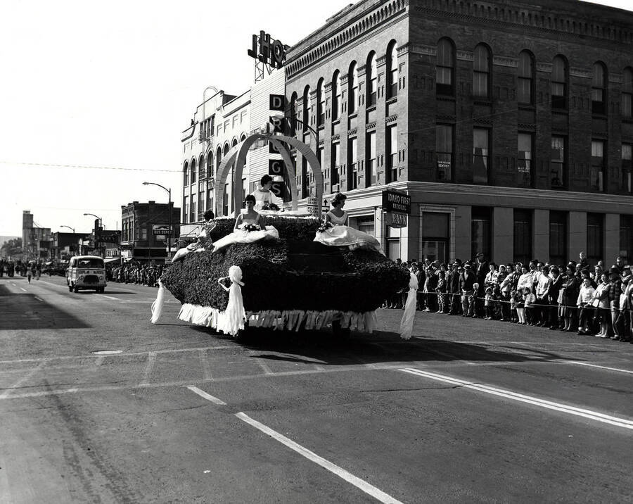 Homecoming queen Toni Thunen and Homecoming princesses  Marge Marshall and Eleanor Unzicker ride on top of a float in the Homecoming parade.