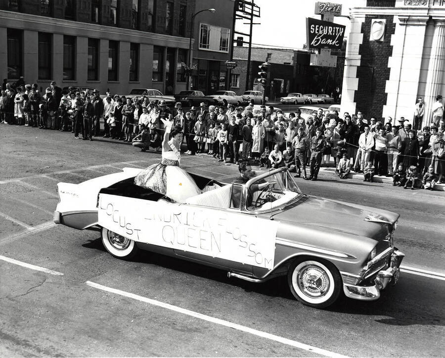 The Kendrick Locust Blossom Queen rides in a car during the Homecoming parade.