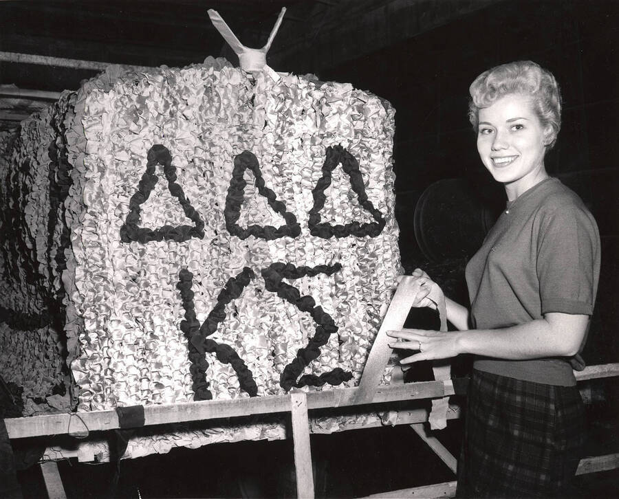 Charmaine Deitz, Homecoming queen,  works on the Delta Delta Delta Kappa Sigma homecoming float.