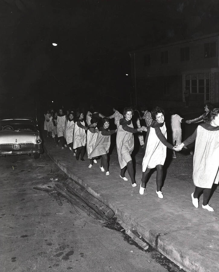 Women from different living groups and residence halls participate in the Pajama Parade the night before the Homecoming game.