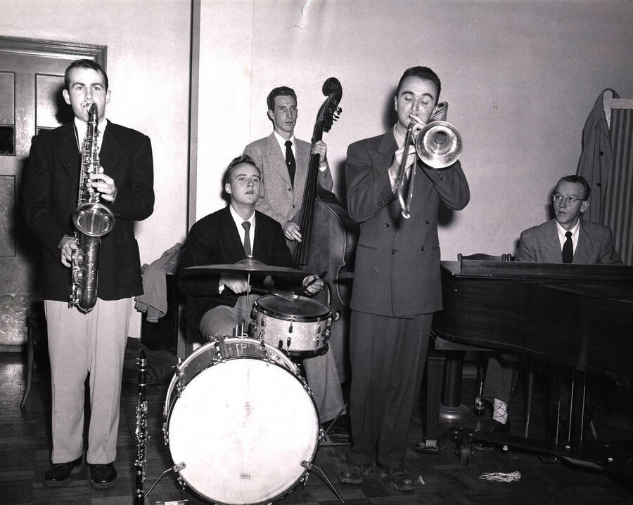 Ray Cox and his Orchestra warming up for the Homecoming dance in the Memorial Gymnasium. Pictured left to right: Rod Bureon, Jim Varley, John Stover, Dave Clark and Ray Cox.