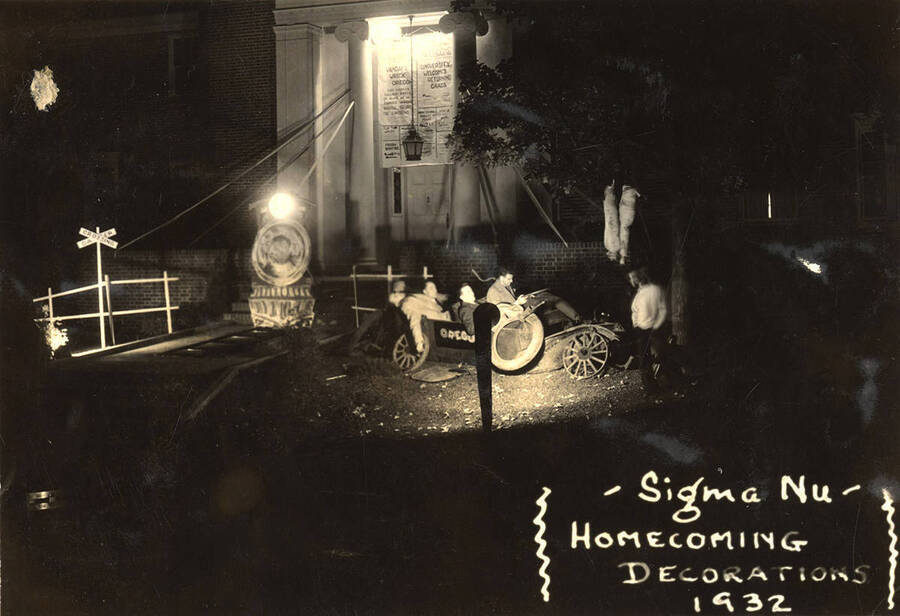 Sigma Nu's house decorations for Homecoming featured house members sitting in a broken down car with Oregon written on the side.