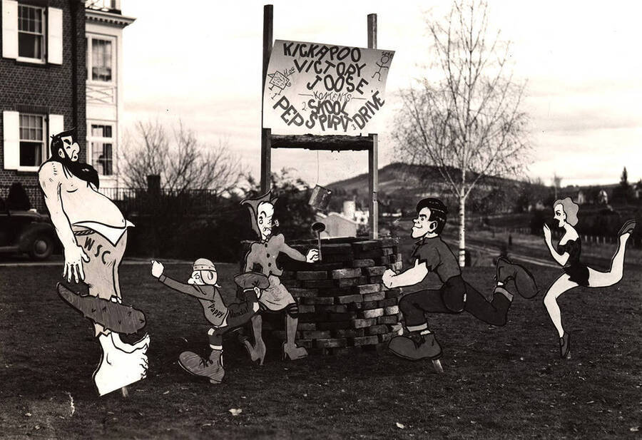 Sigma Alpha Epsilon's Homecoming house decorations portray "Pappy Vandal" beating WSC (Washington State College).