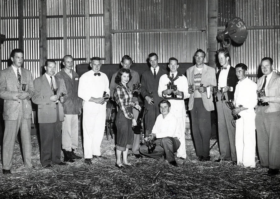 Queen Beverly Bressler presents honors to Don Wagoner, among others, during Idaho's Little International Agriculture Show. Students identified from left to right: Claude Morrow, Glenn Hart, Bill Larson, Francis Flerchinger, Doug Weinmann, Robert Day, Ralph Hart, Jim Baggett, John Wienmann, George Hosoda, and Gerald Comstock.