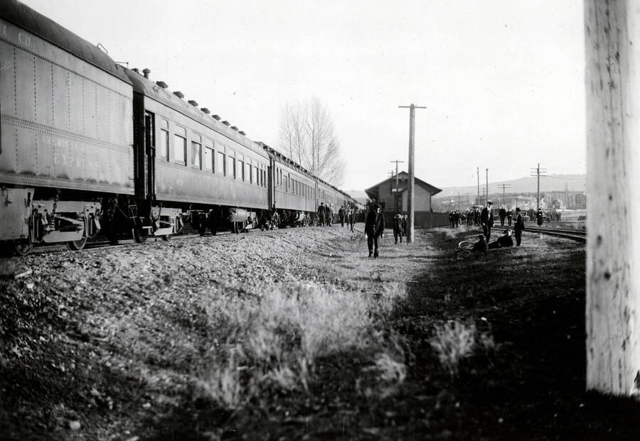 People wait beside the Student Special train where students are arriving from Southern Idaho to attend the Armistice Day football game.