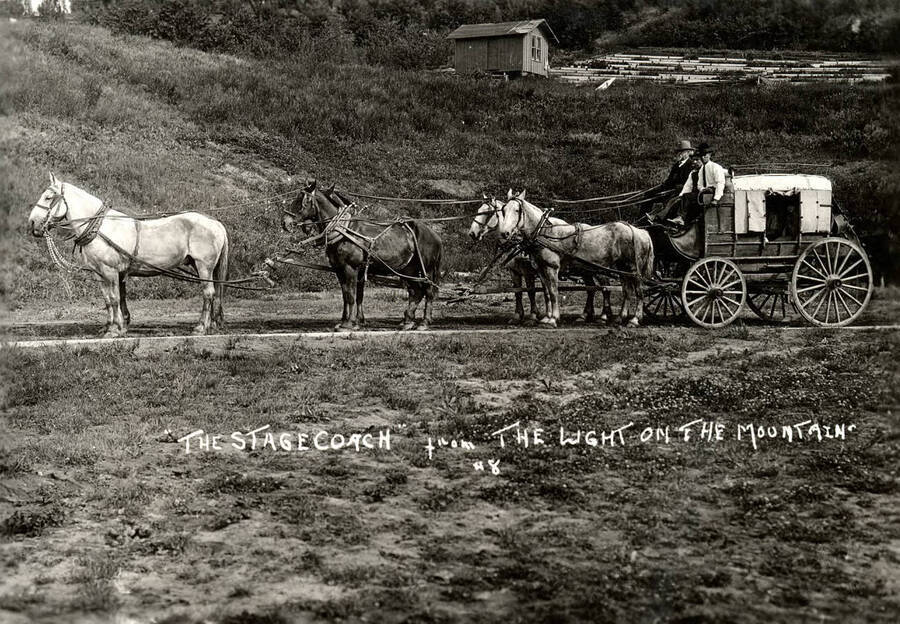 Felix Warren drives a six-horse stagecoach with two companions, all wearing 19th century western garb in the Light on the Mountains pageant. Caption reads: ''The Stagecoach' from The Light on the Mountain #8.'