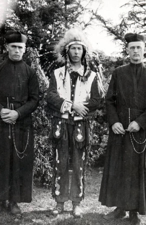 L.N. Wilson and Bryan Bundy dressed as priests, Father DeSmet and Father Point, standing beside an unidentified man dressed as a Native American chief for the Light on the Mountains pageant.