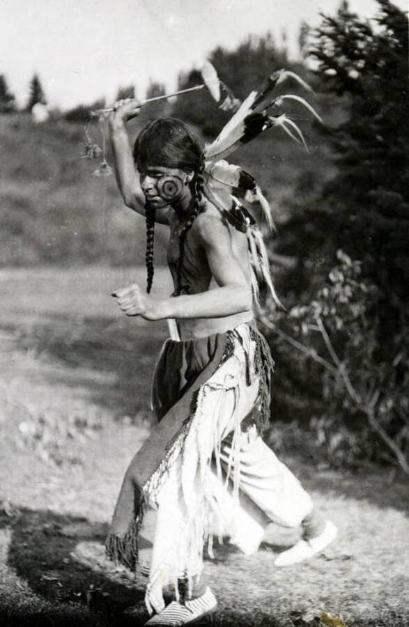 An unidentified man dressed as a Native American swings an axe prior to the Light on the Mountain pageant.