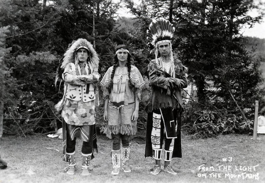 J. Ray Burbidge, Jeannette Greve and Vivian Kimbrough pose respectively as "The Dreamer," Sacajawea and Speaking Eagle for the Light on the Mountains pageant. Caption reads: "#3 From "The Light on the Mountains."