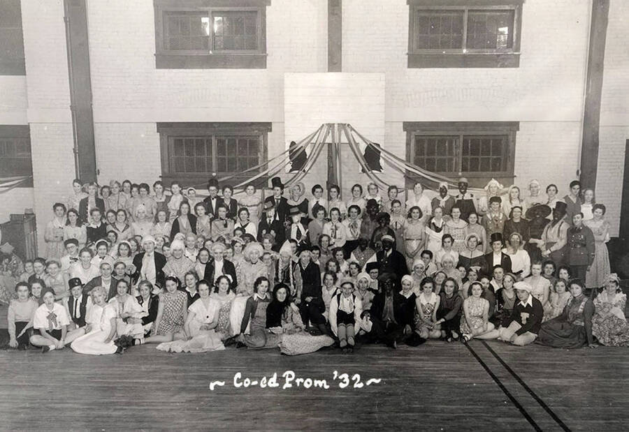 Students pose during the Co-ed Prom inside the women's gymnasium. Caption reads: "Co-ed Prom '32."