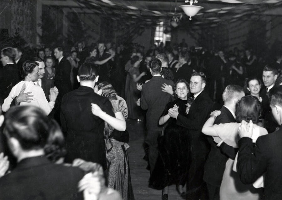 Students dance, two smile for a photograph during the annual Forester's Ball.