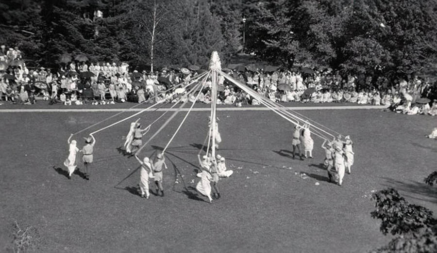 Students watch pairs perform the Maypole dance during Idaho's Campus Day celebrations.
