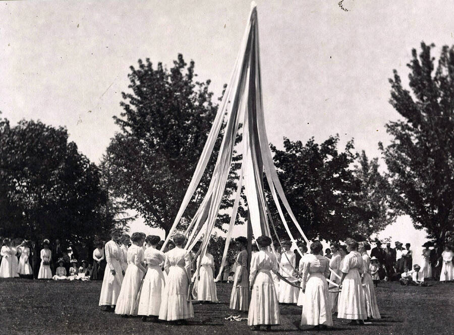 Hosts of students observe as performers wind the maypole during Idaho's Campus Day traditions.