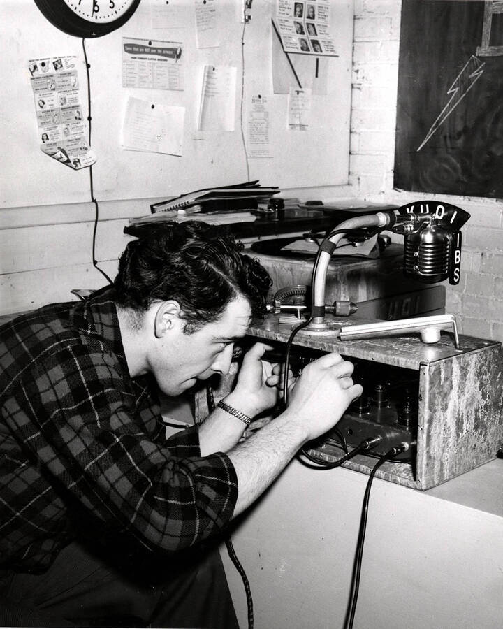 An unidentified student works on equipment in the KUOI studio, Idaho's student-run radio station.